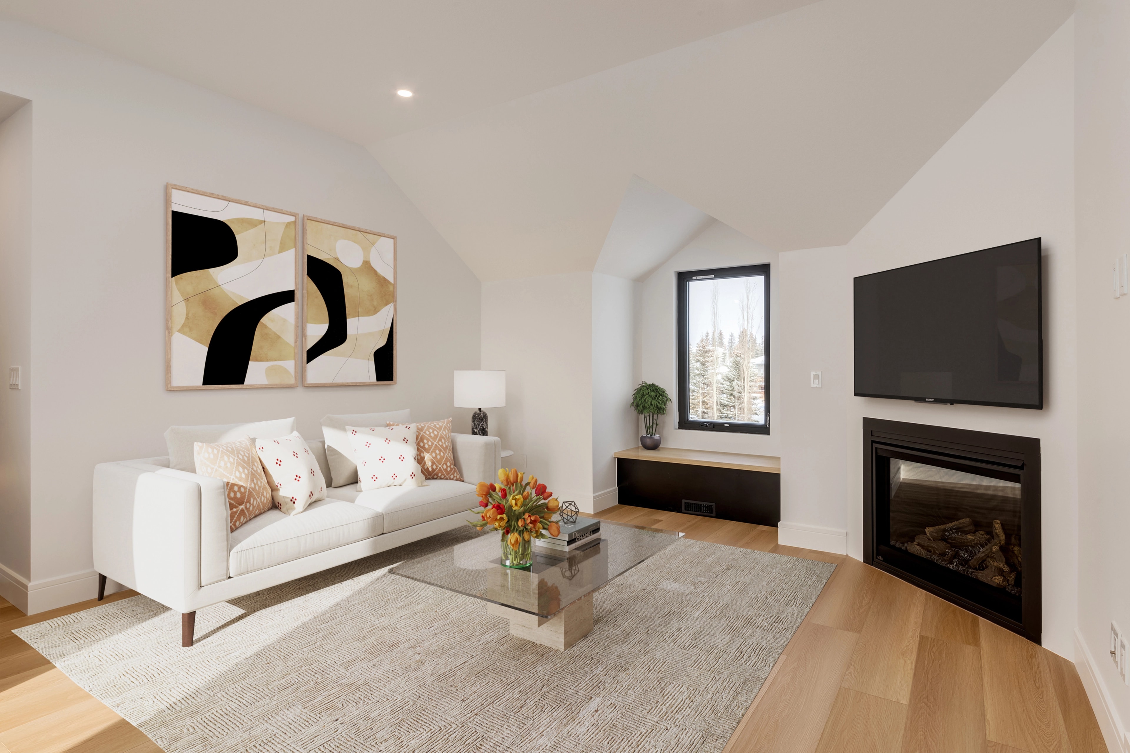 Bright vaulted living room with a gas fireplace and colorful abstract art