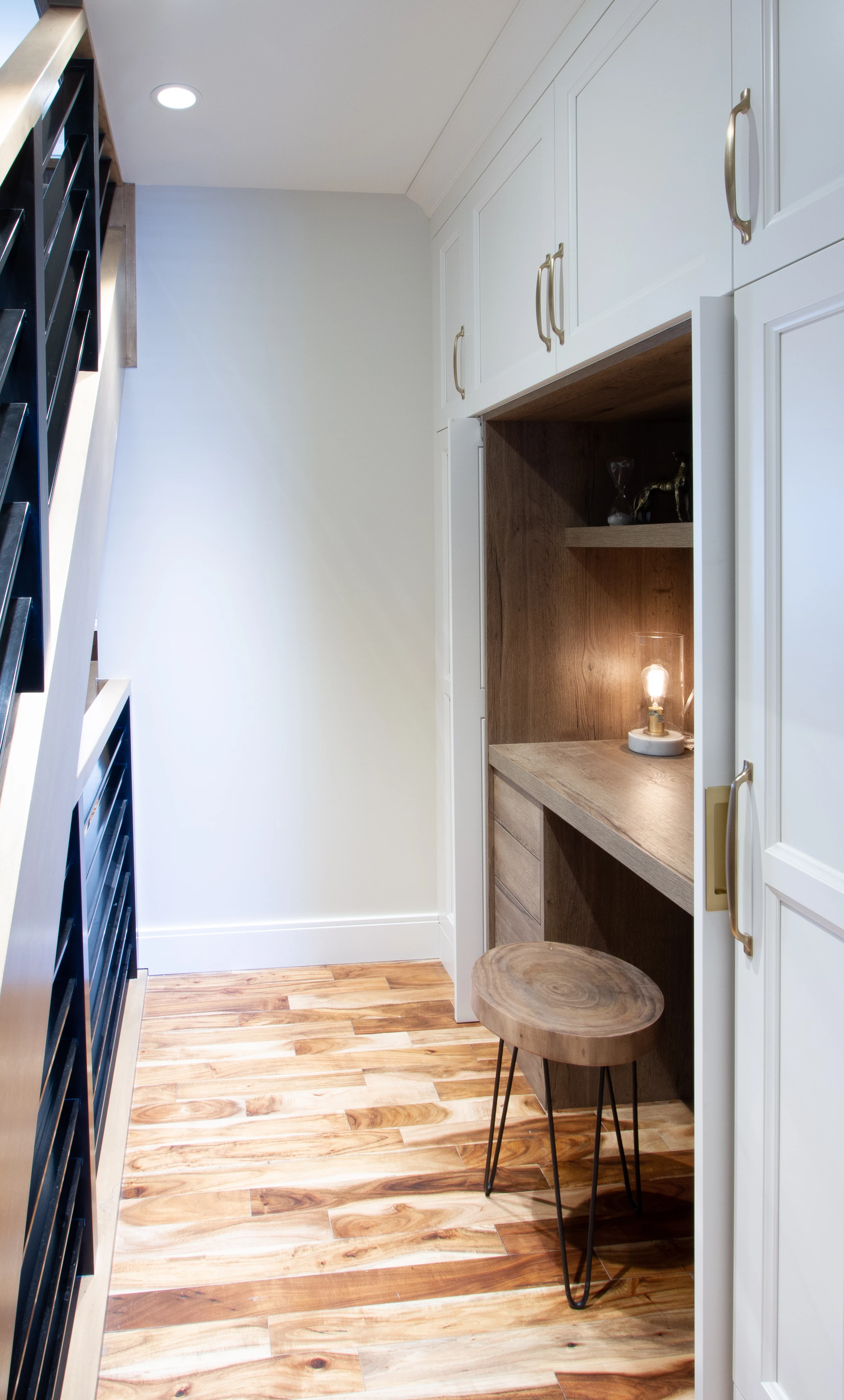 Built-in hallway desk nook with a pendant light beside the stairs