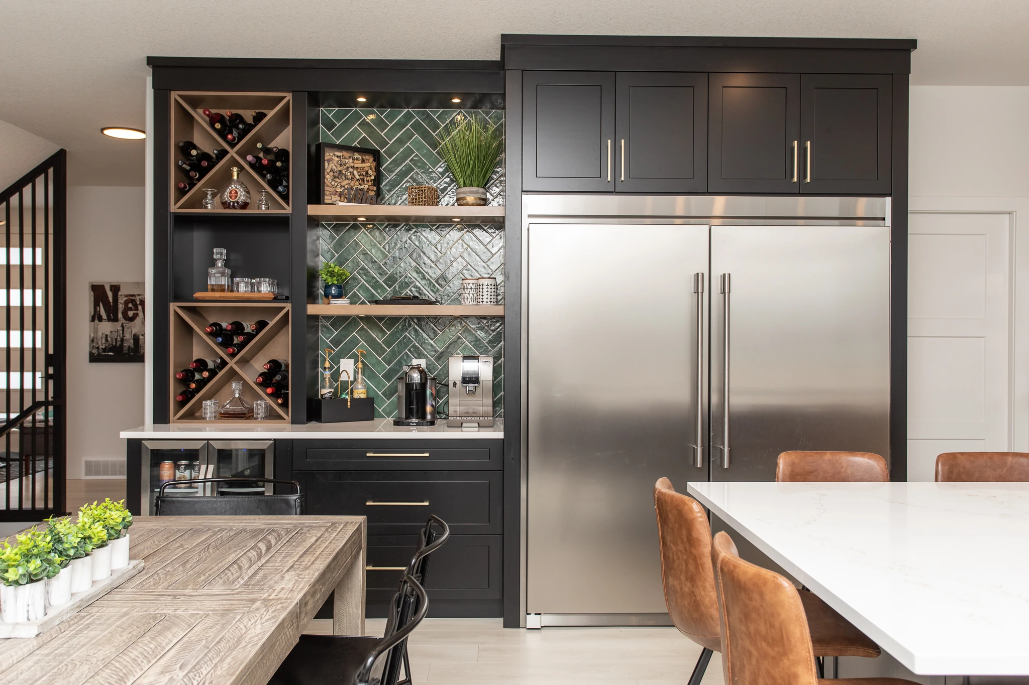 Dark navy butler's pantry with wine storage, herringbone tile backsplash, and a built-in fridge