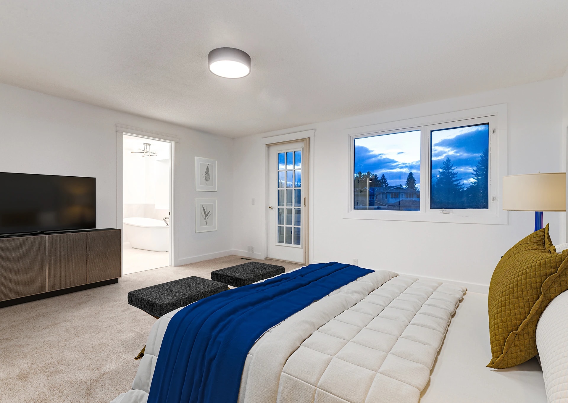 Bedroom with a media console, private patio door, and evening window views