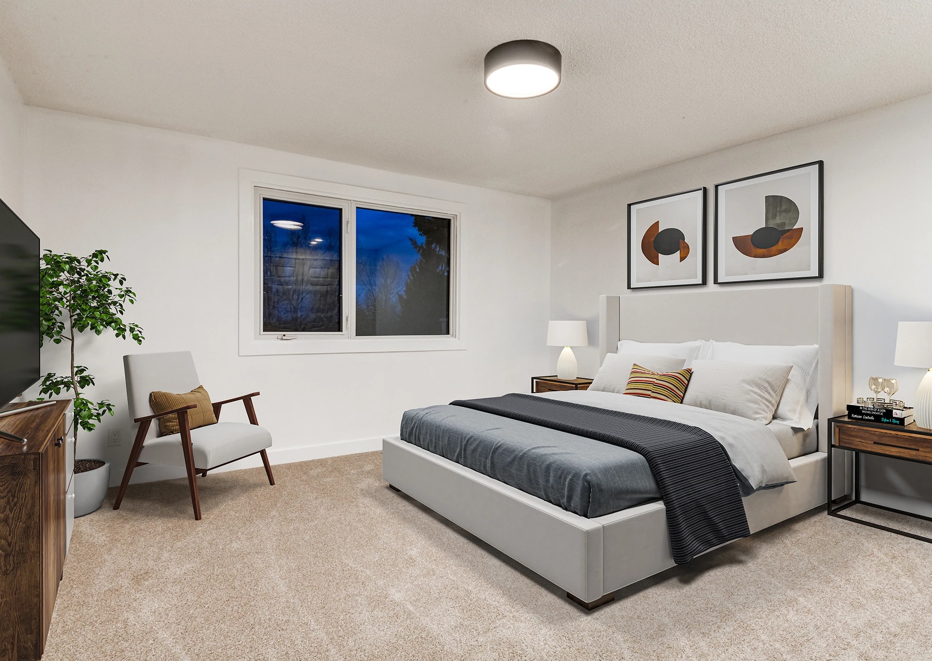 Bedroom with a mid-century accent chair and a pair of framed art prints