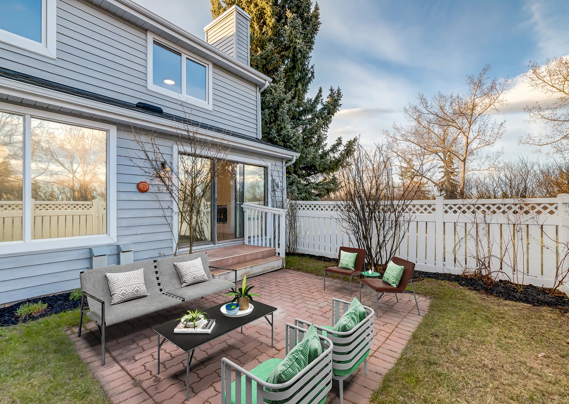 Backyard patio with outdoor seating against the home's exterior