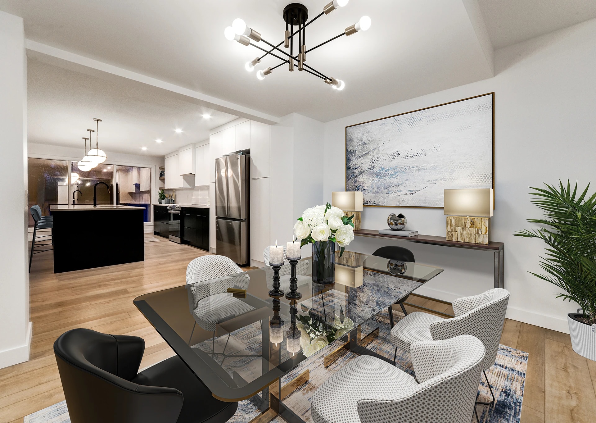 Dining area with a sputnik chandelier and glass table opening to the kitchen