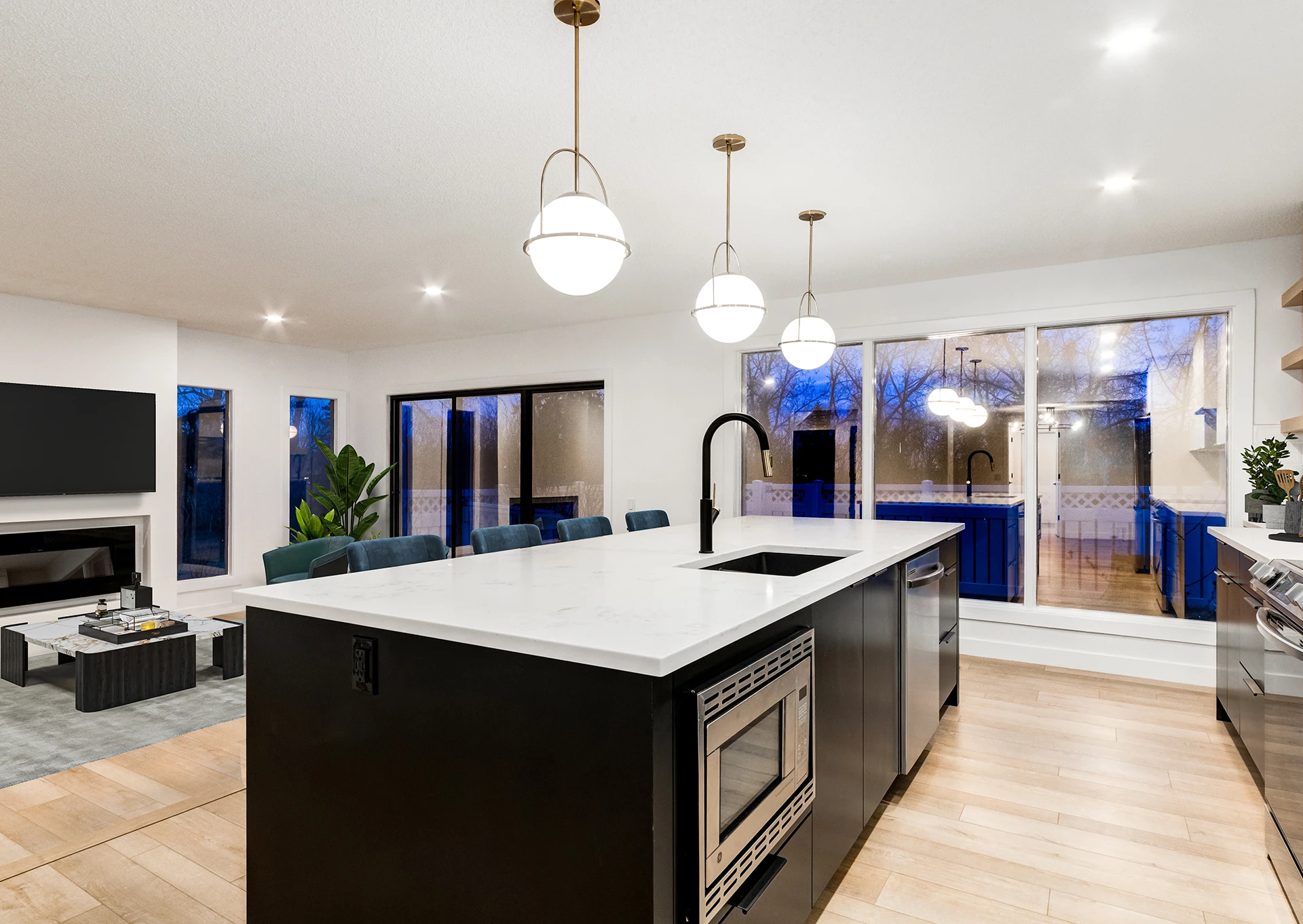 Kitchen island view toward a blue-tiled sunroom beyond